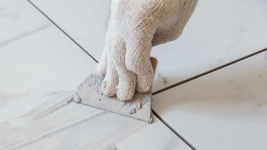 Woman grouting tiles