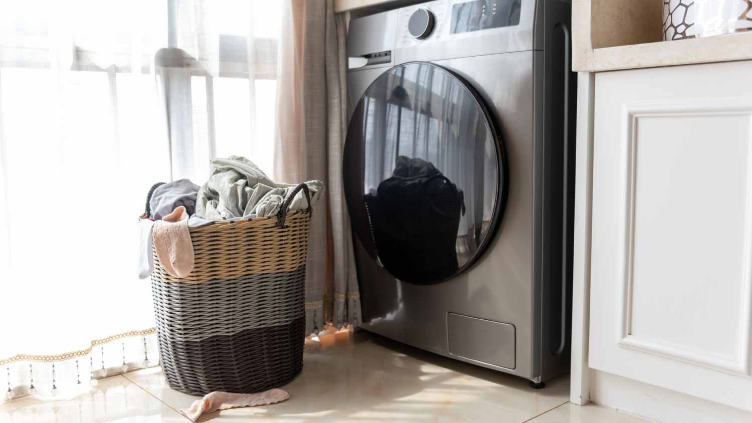 Basket with dirty laundry on floor