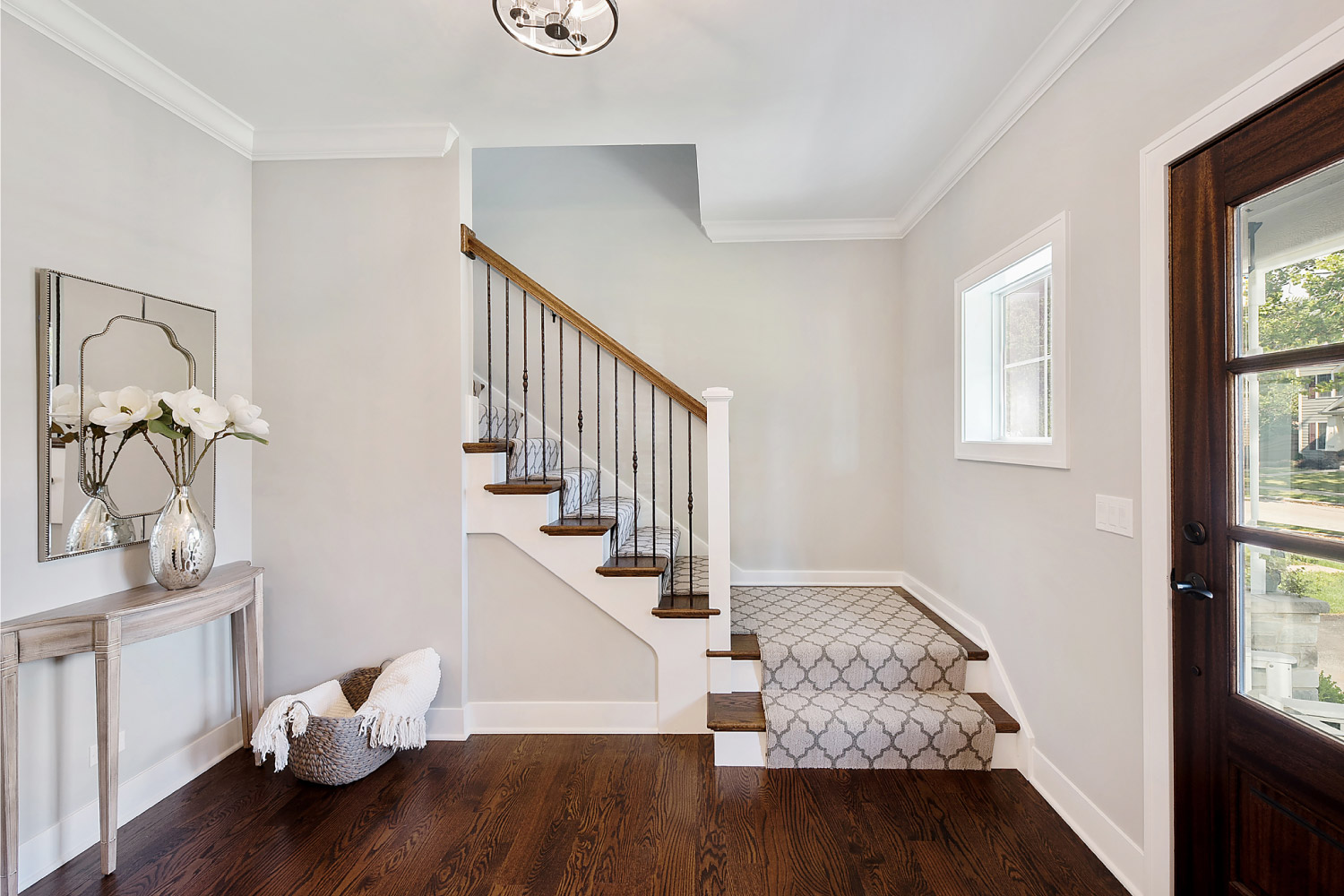 A house front entrance with partially carpeted stairs