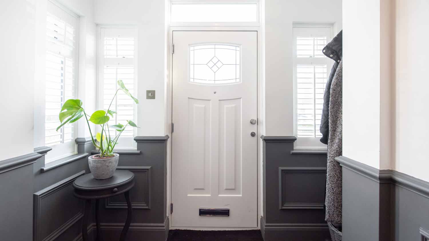 Hallway with white front door