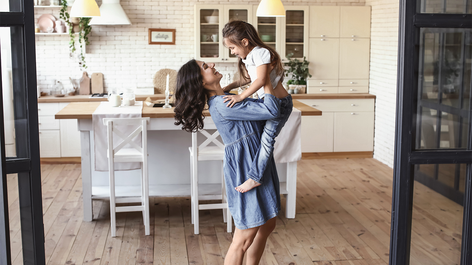MOTHER AND DAUGHTER HAVING FUN IN KITCHEN 