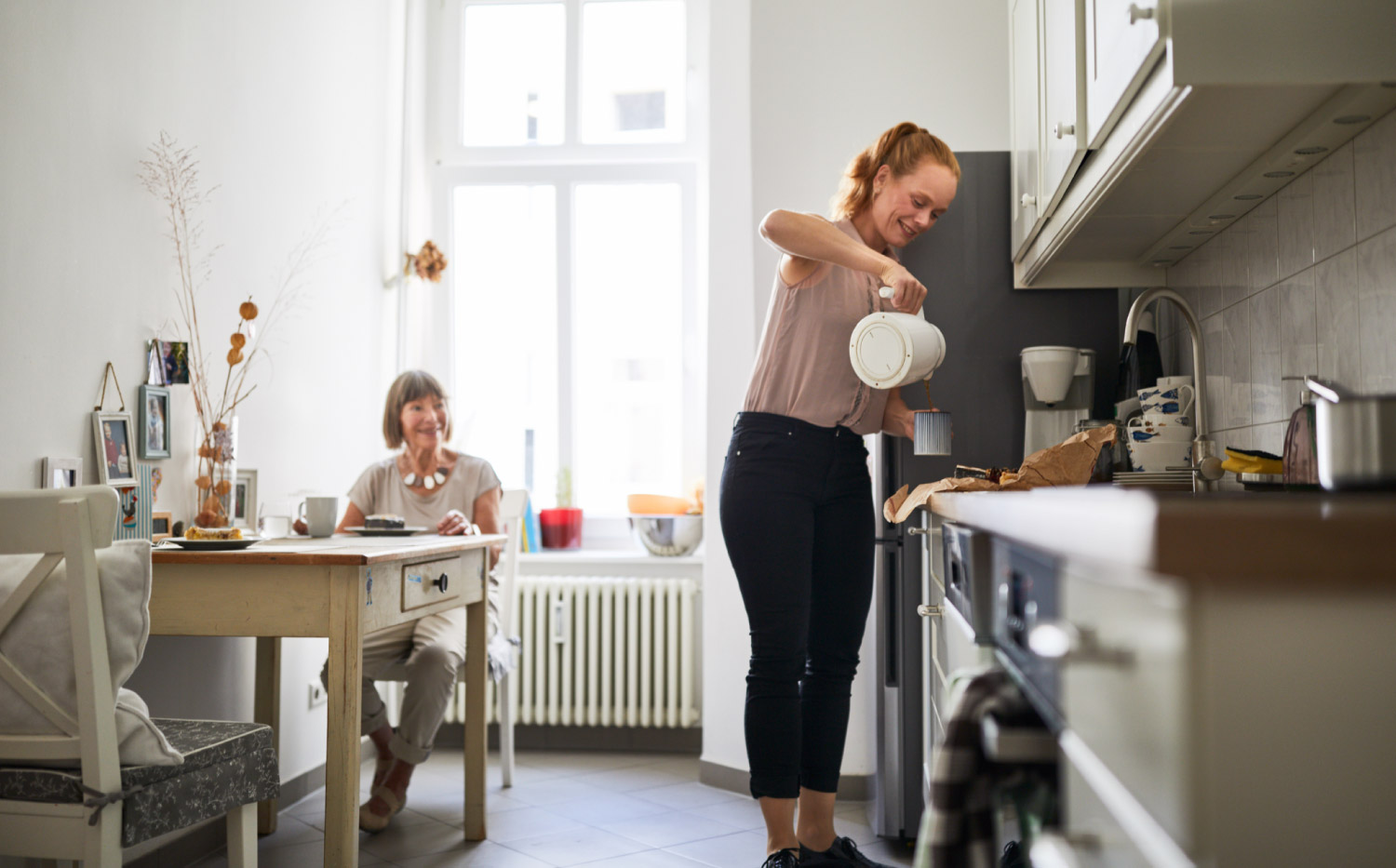A woman preparing coffee in the kitchen