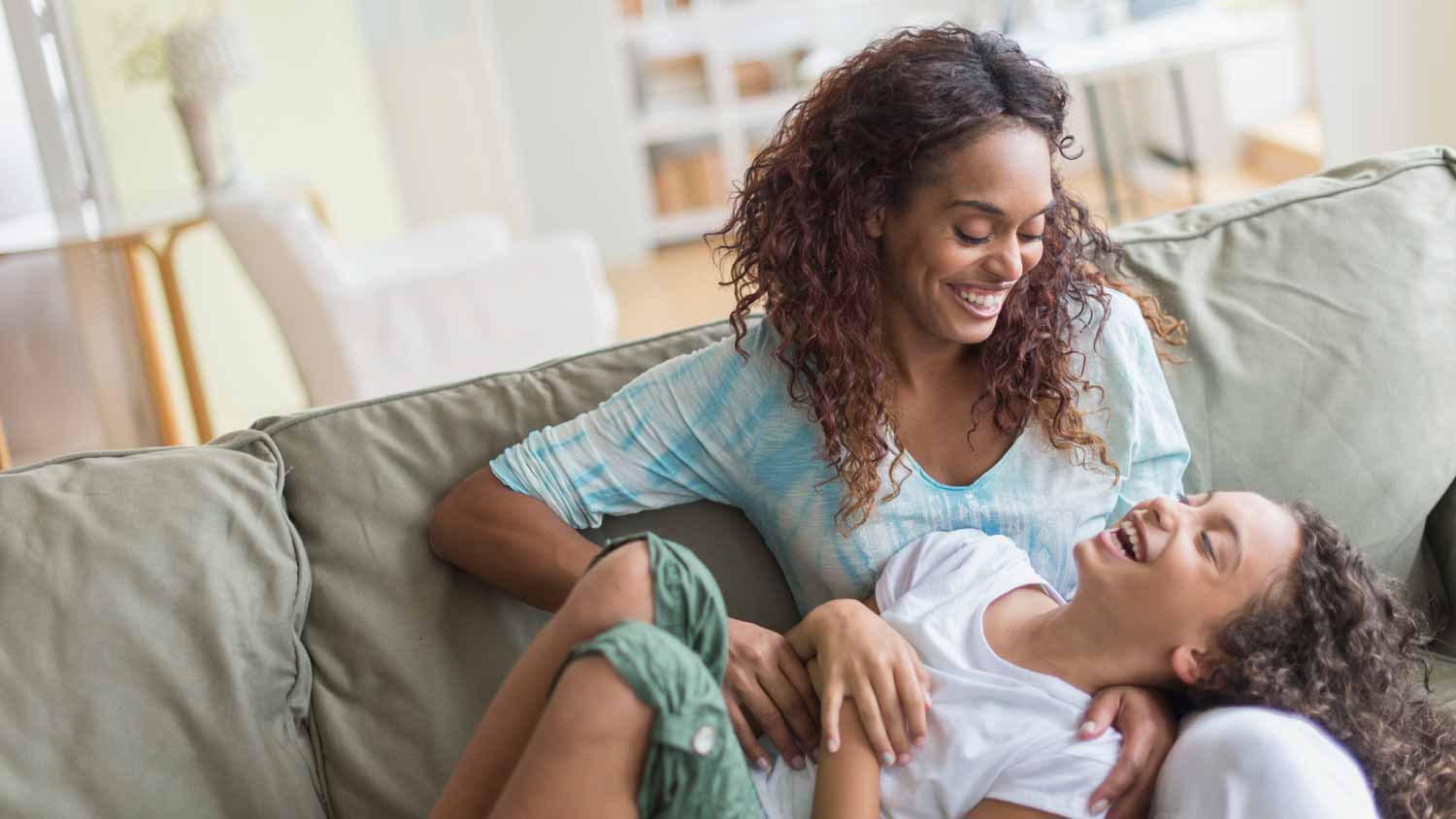 Mother tickling daughter