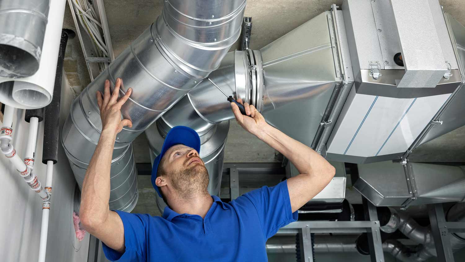 worker installing duct system