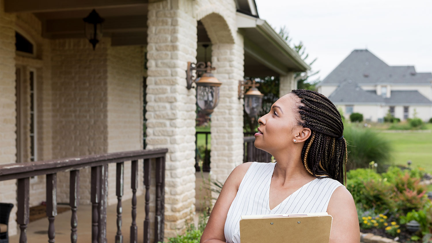 An appraiser stands in front of a house