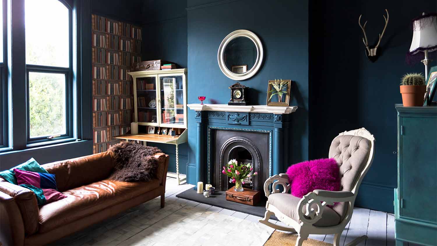 A view of a blue living room with fireplace