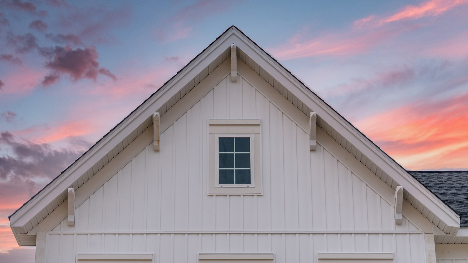 A house with a board and batten siding in sunset