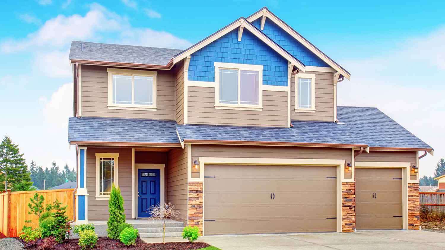 Brown and blue wooden siding installed on a suburban house
