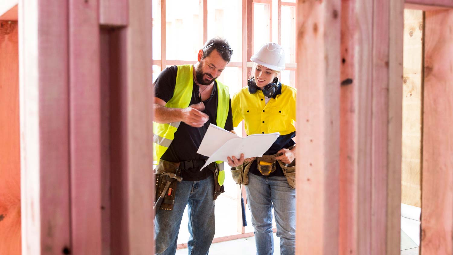 A builder and a general contractor discussing about the plans of the house
