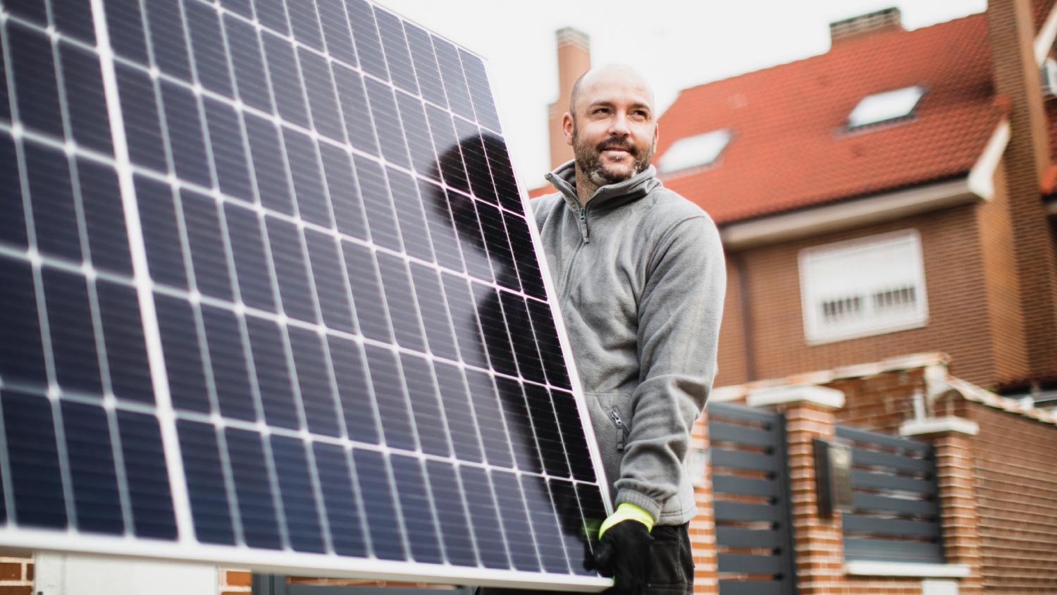 Construction worker installing solar panels