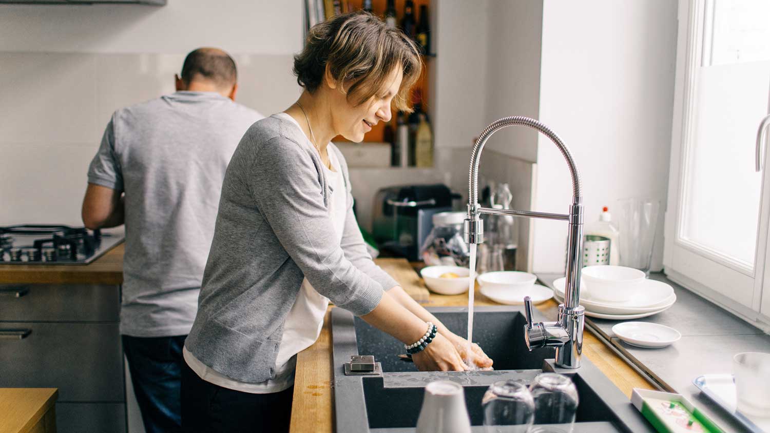 Couple at home cleaning the kitchen together