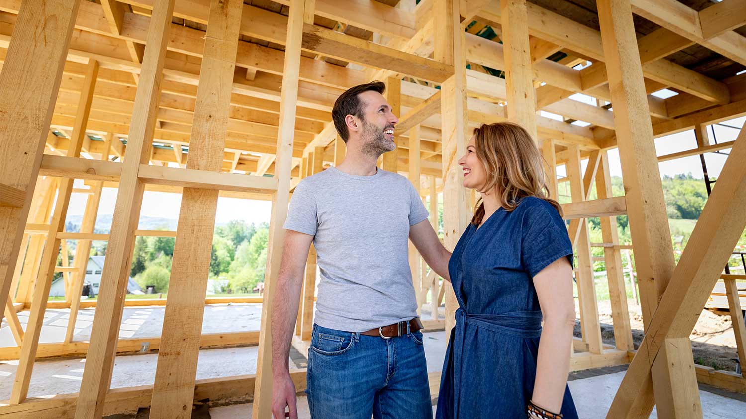 couple standing in construction of new home