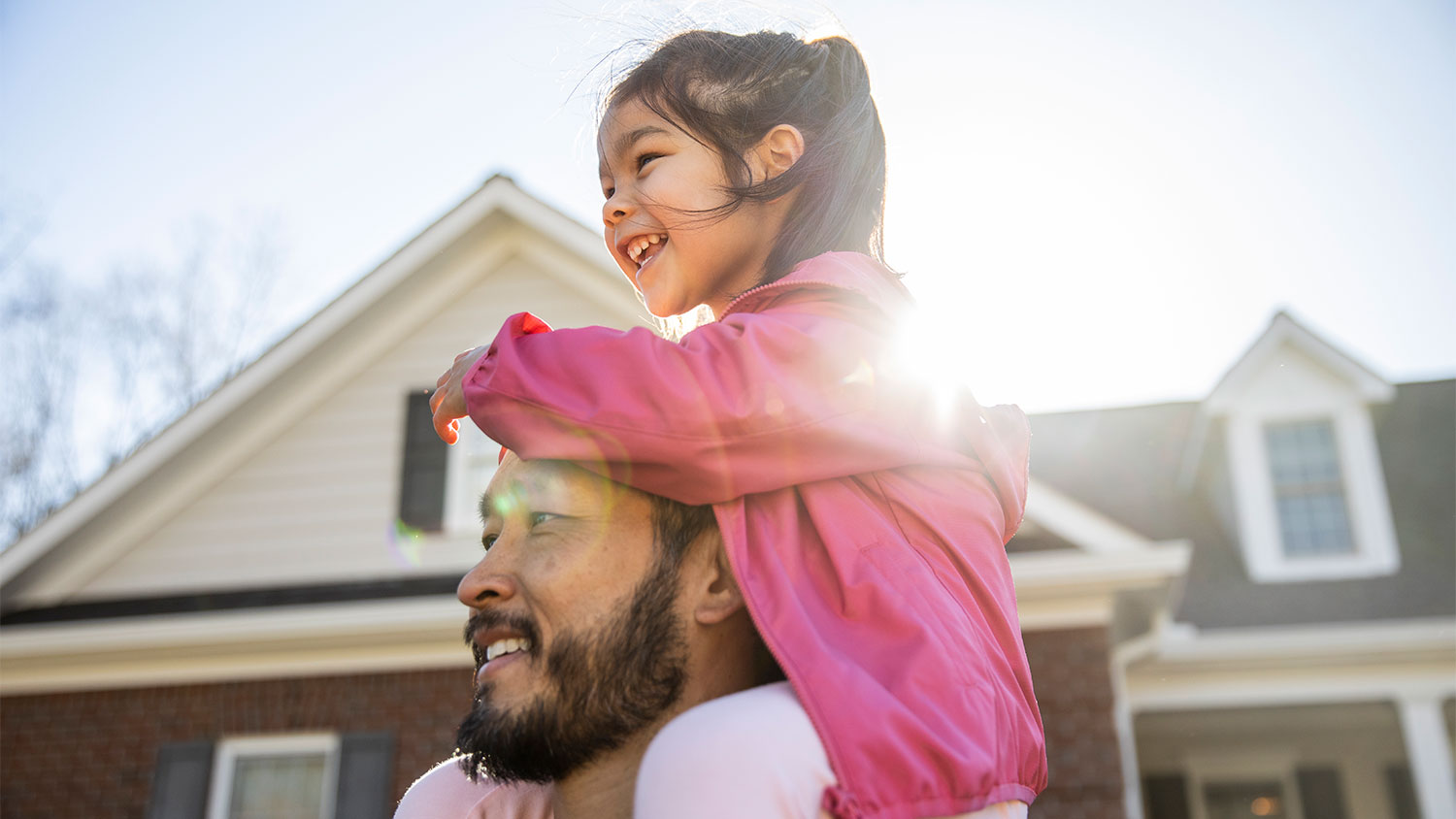 Father and daughter outside house