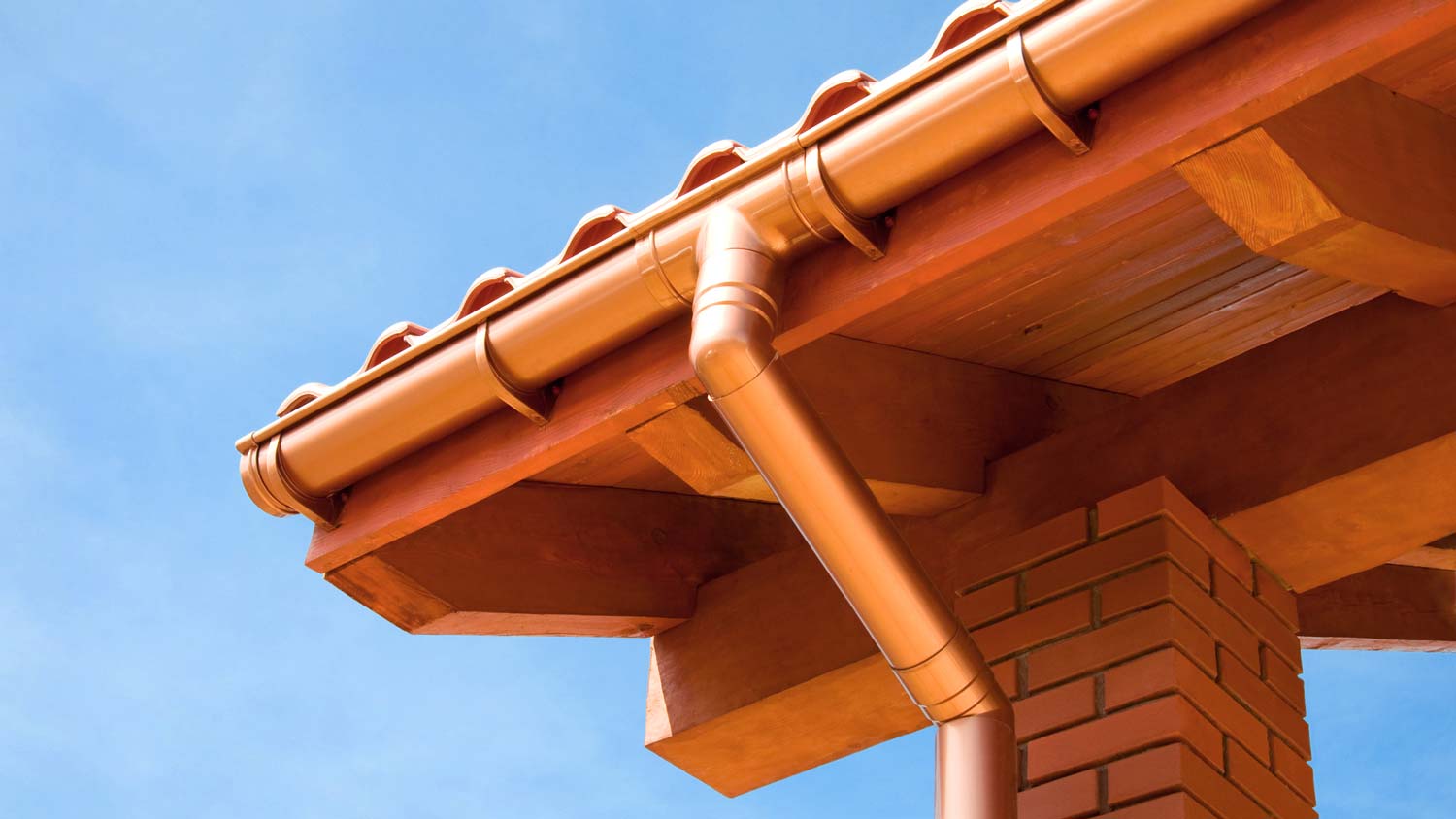 Faux copper gutters against the blue sky