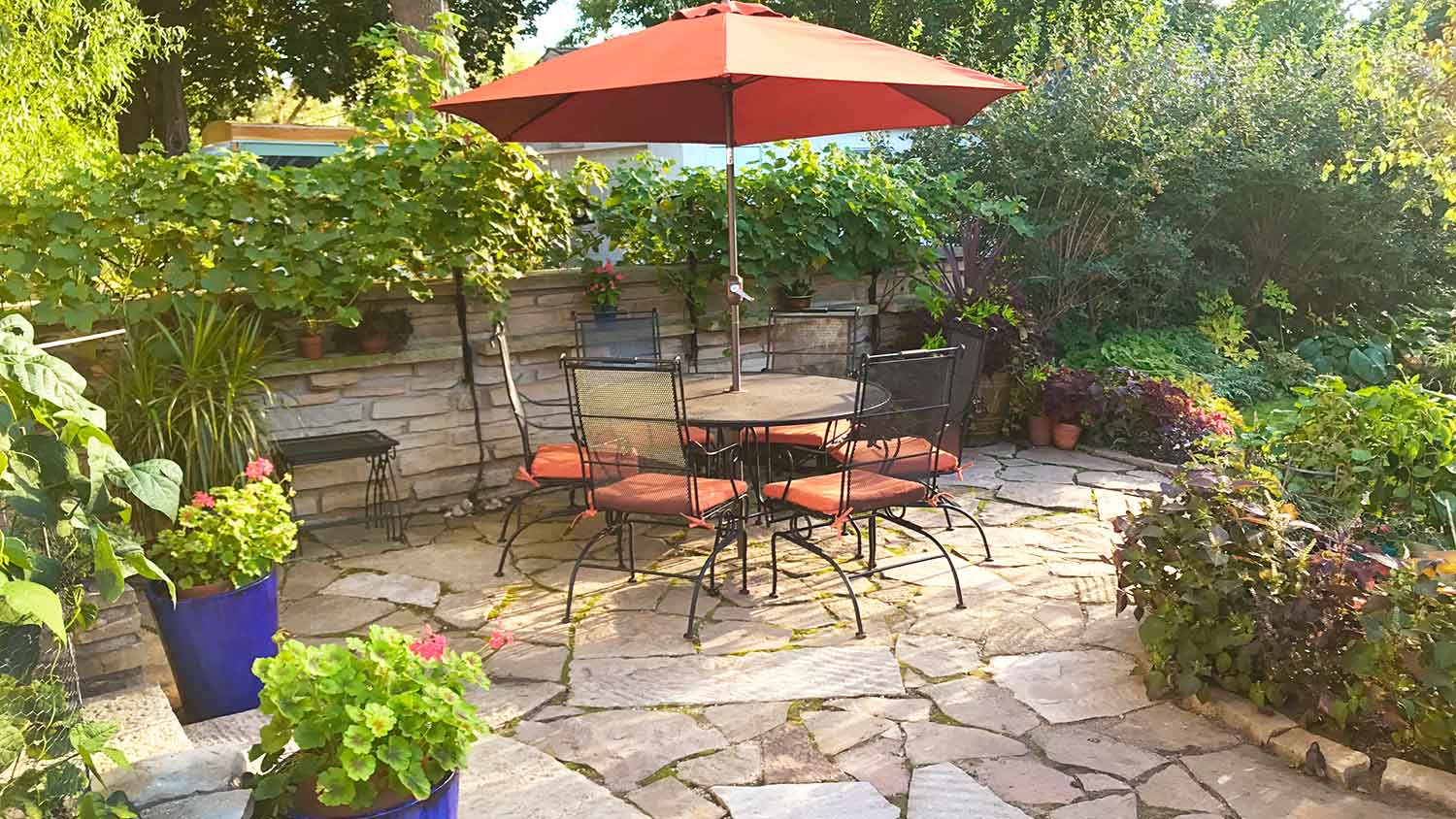 Outdoor table and umbrella on a flagstone patio