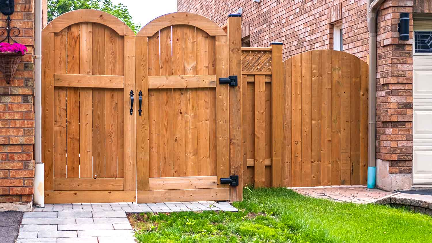 Brick house with wooden gate in the front yard 