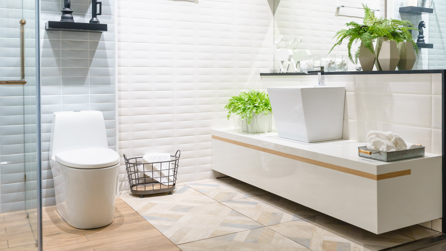 The interior of a modern bathroom with a white toilet