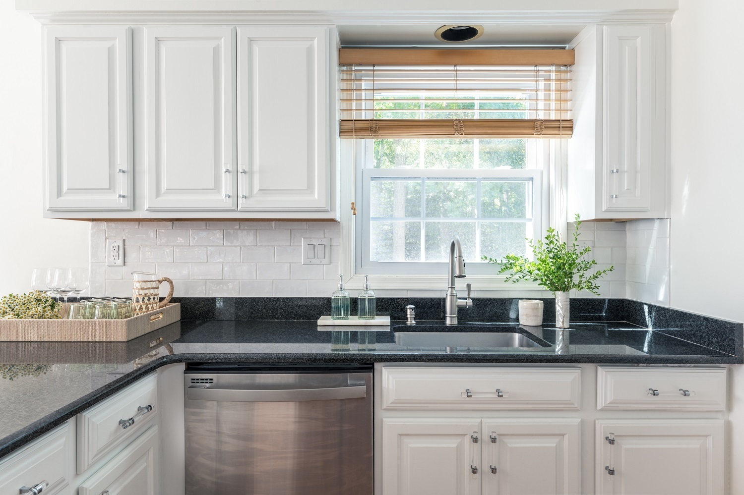 A kitchen with white cabinets