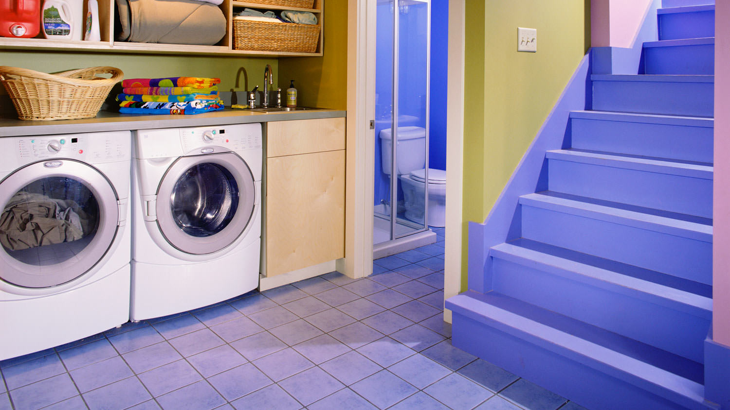 A finished laundry room in the basement of a house