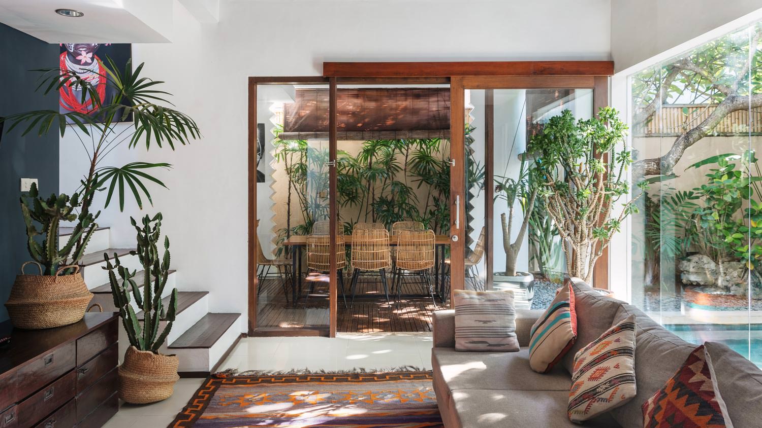 A living room with an ethnic decor and intricate rug