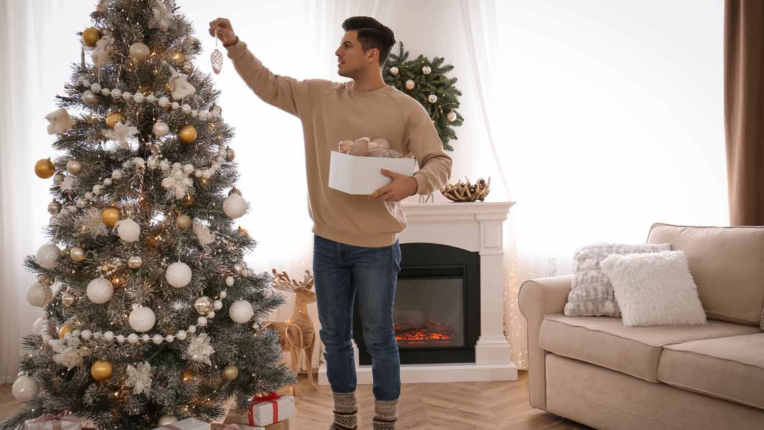 A man decorating a Christmas tree