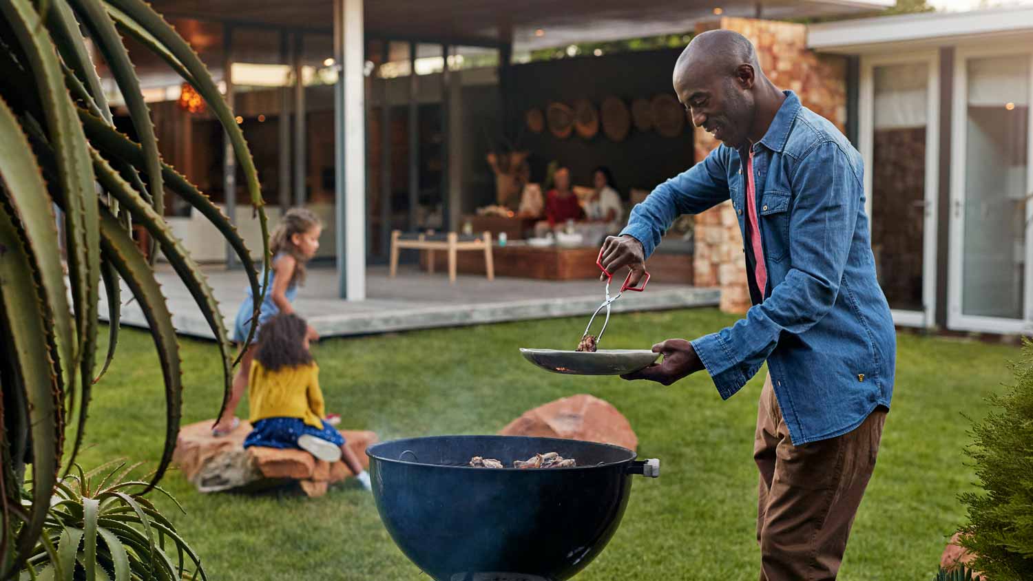 A man grilling in his yard