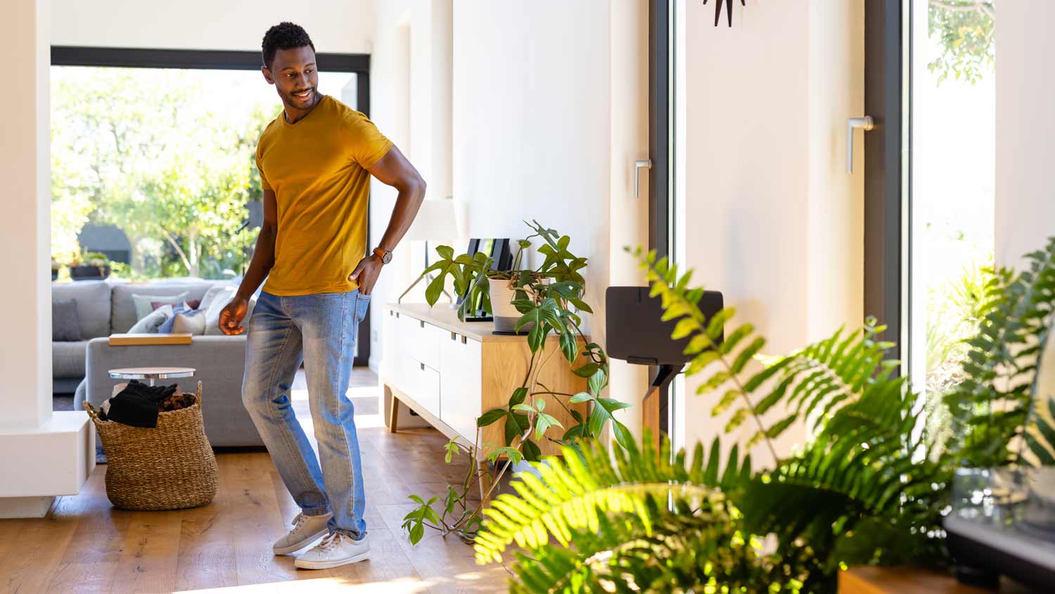 man in home surrounded by plants