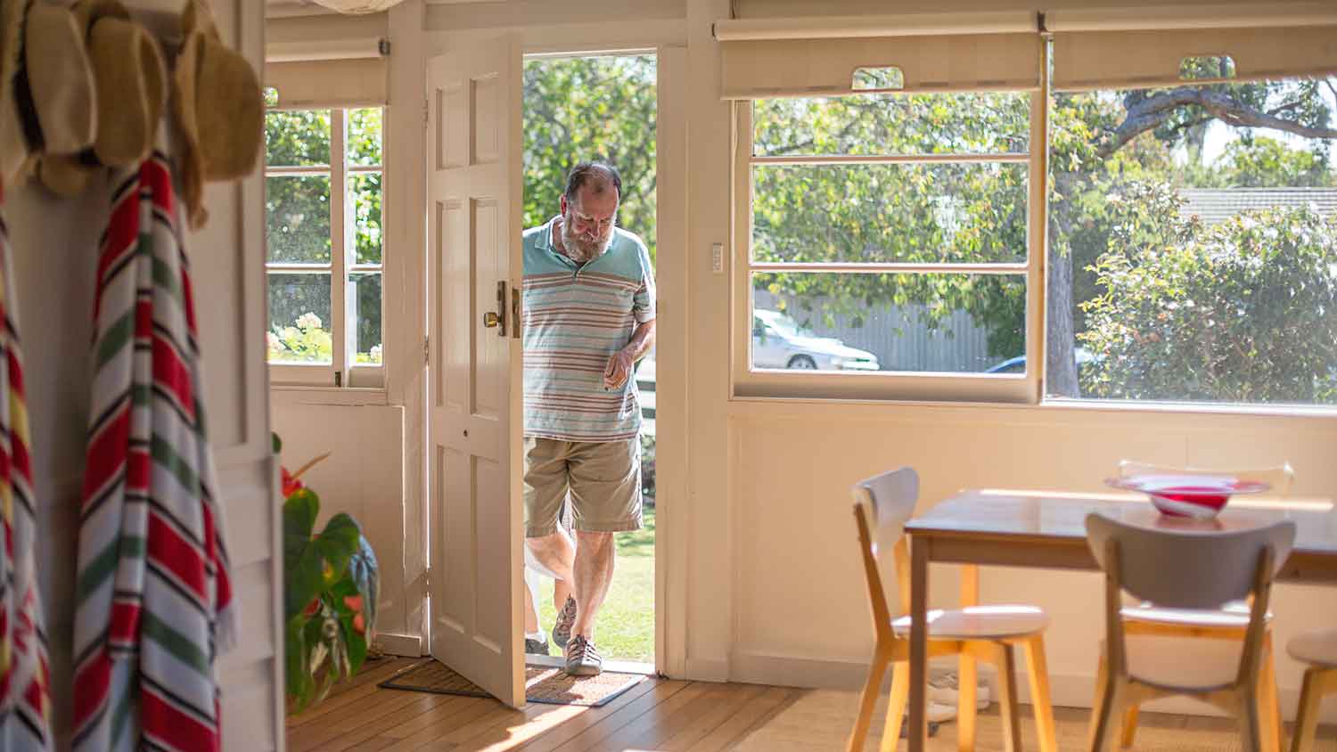 Man opening front door to enter his house