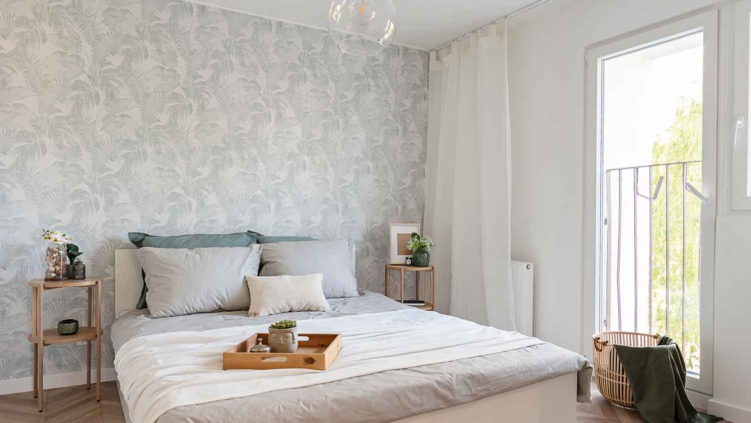 Bedroom with queen size bed and wallpaper accent wall