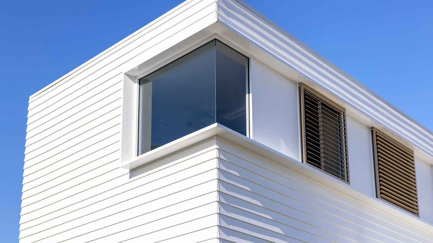 Composite cladding installed on a white modern house
