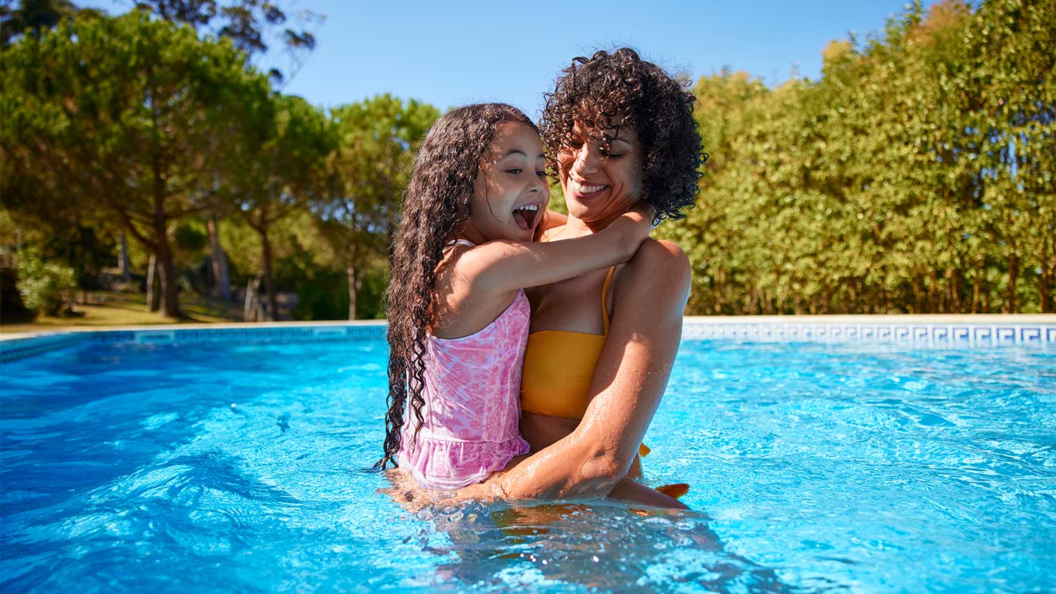 Mother and daughter in swimming pool
