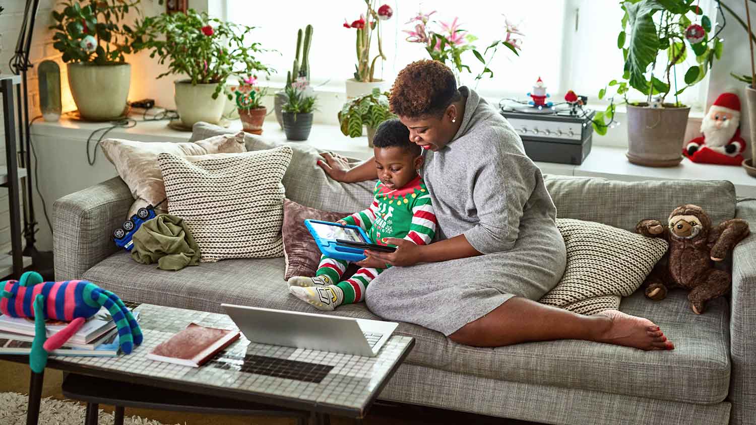 Mother and son sitting on the couch and reading a story