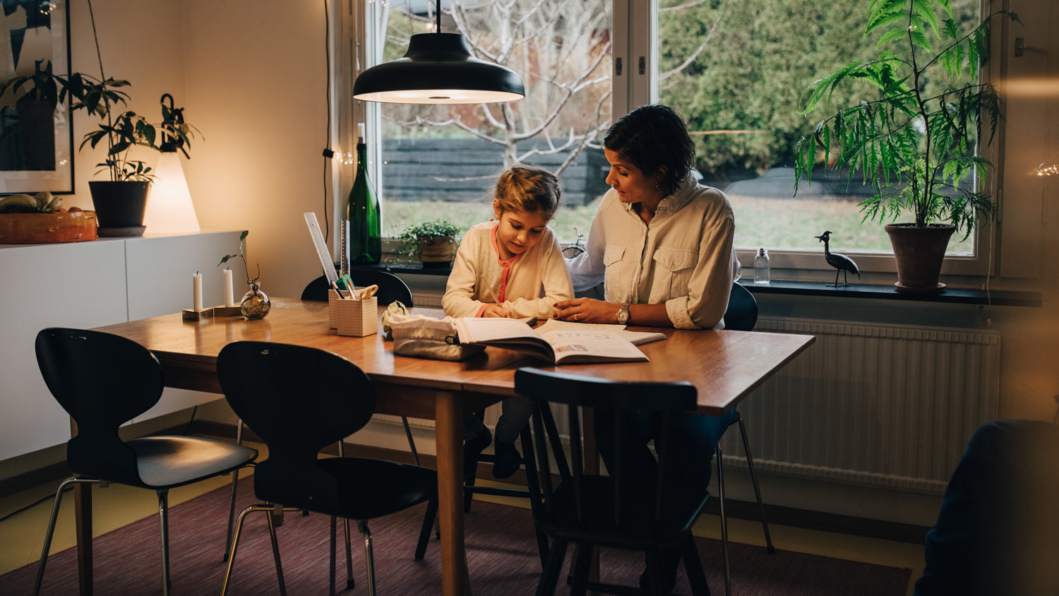 A mother assisting her daughter with homework 