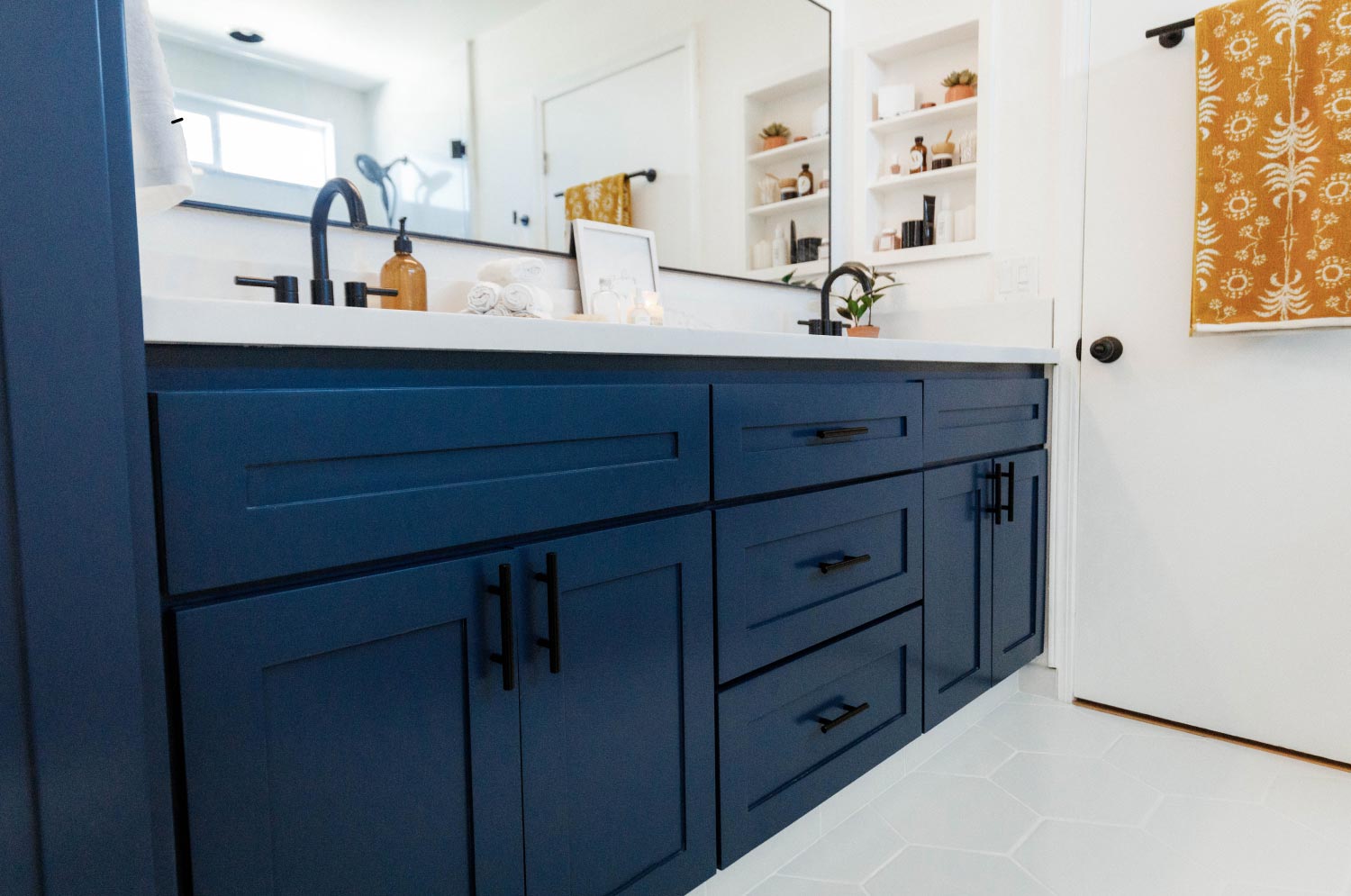 navy blue vanity in white bathroom