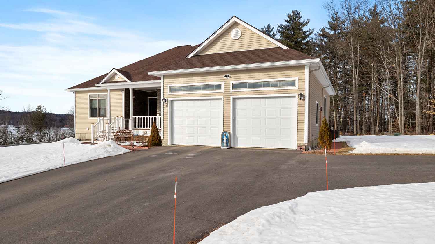 Rural house with large driveway and two garages