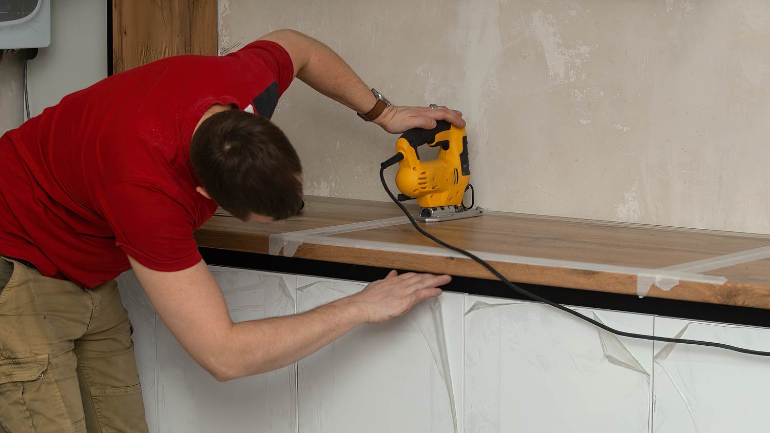 man securing  butcher block countertop