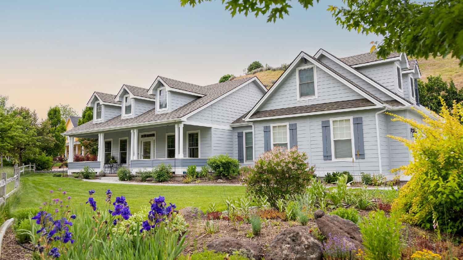 A suburban house with lawn and a flower bed
