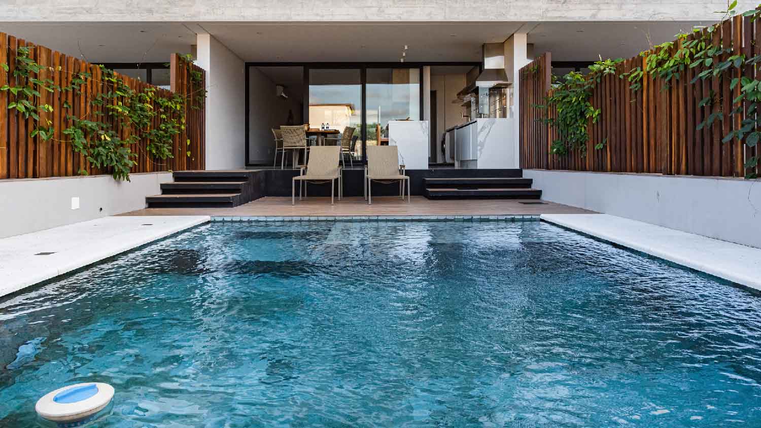 A swimming pool at the back of a house