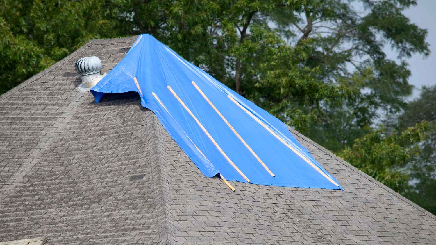 Tarp on a part of a roof 