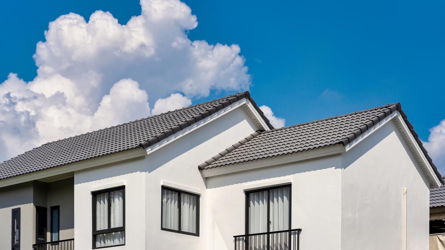 The upper floor of a house and its shingled roof
