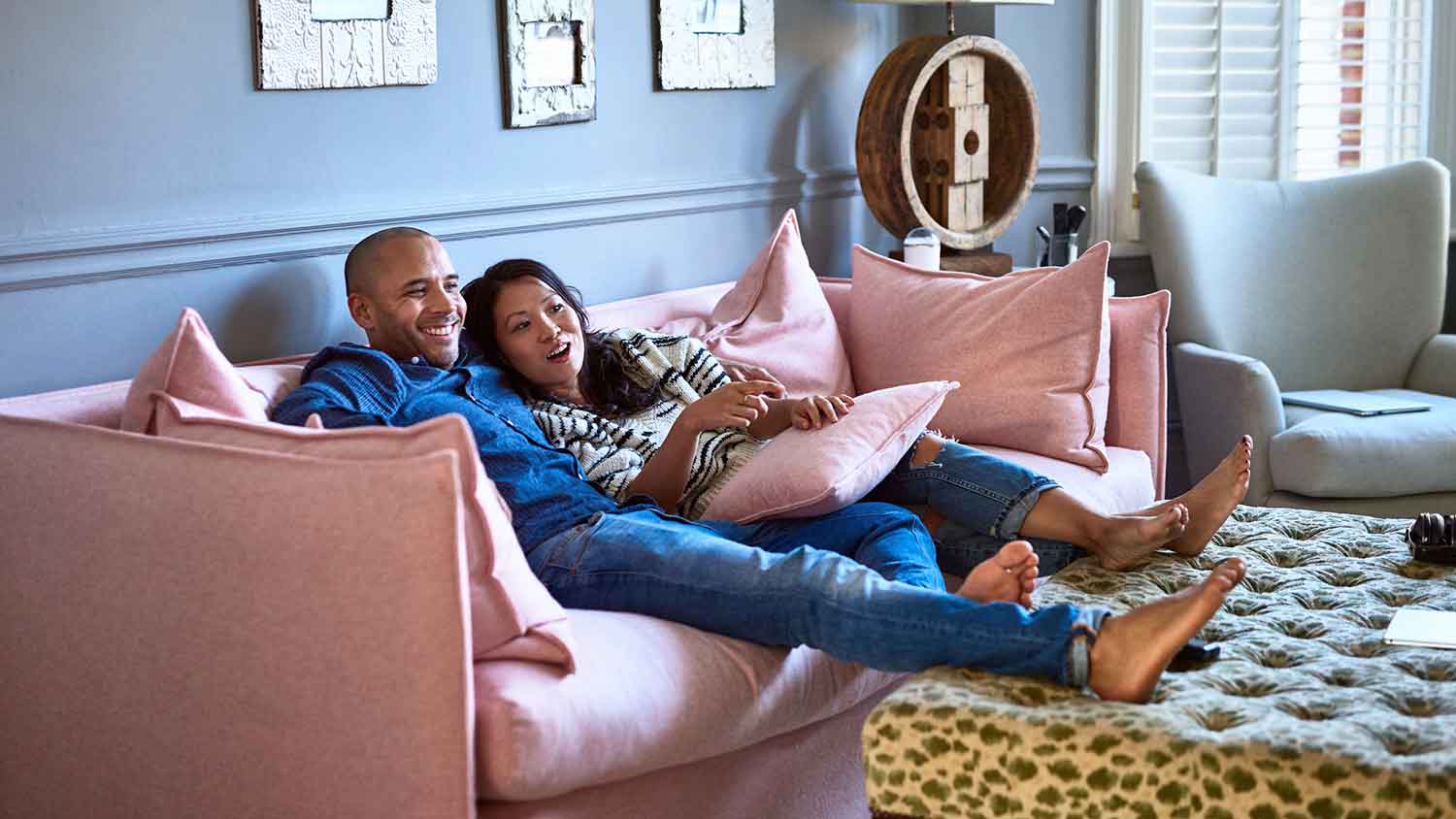 Couple sitting on a sofa watching tv 