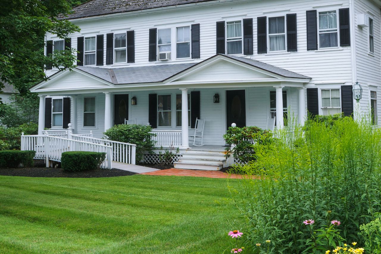 big white house with ramp entrance