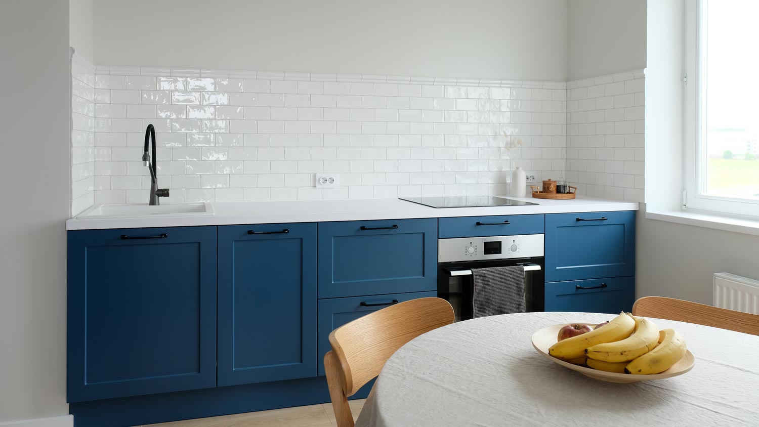 A white tiled kitchen