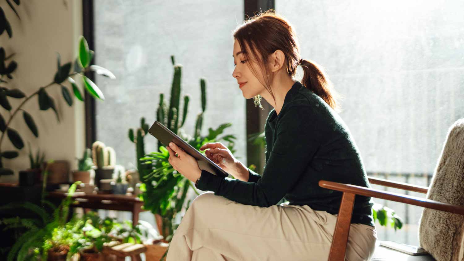 woman using digital tablet at a cozy living room