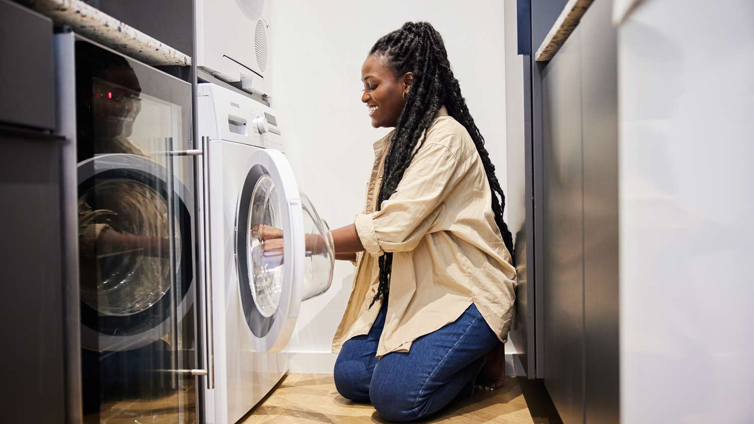 woman smiling washing clothes