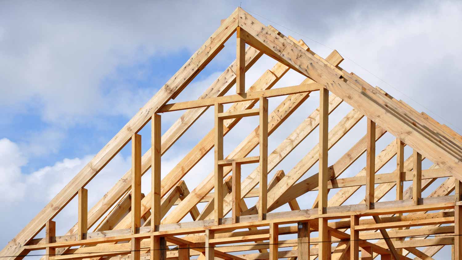 A wooden frame of a house’s roof