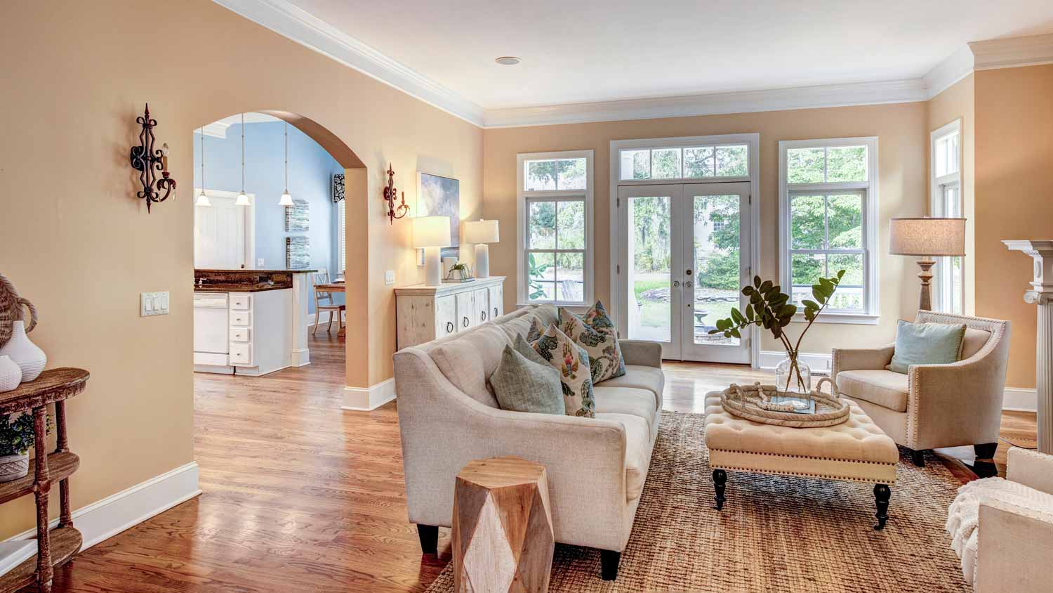 spacious yellow living room with crown molding  